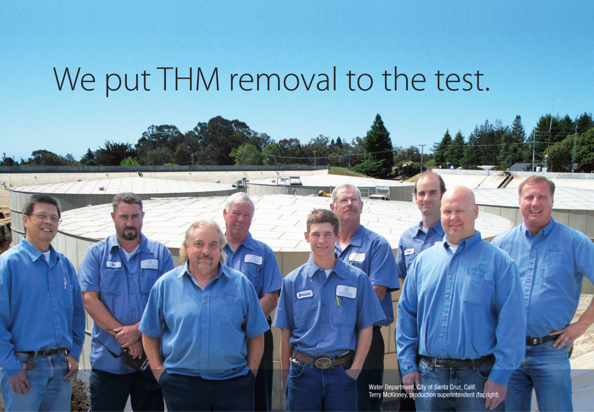 Happy customers posing near tank with caption "We put THM removal to the test"