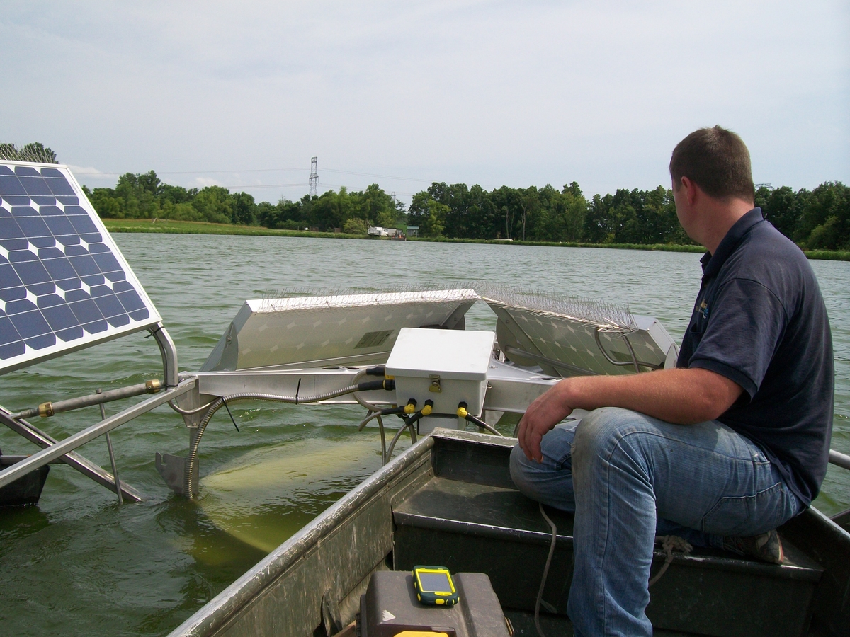 Medora Corporation Crew testing water next to a SolarBee®